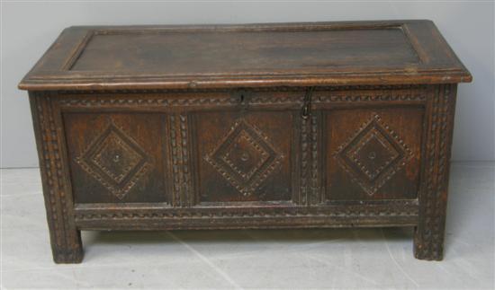 Appraisal: th century oak coffer with panelled carved lozenge front and