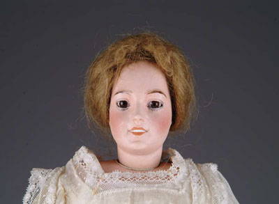 Appraisal: LIMOGES GLASS-EYED LADY A Limoges head on bisque shoulder plate