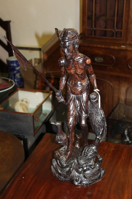 Appraisal: A HARDWOOD CARVING of a river fisherman with trained cormorant