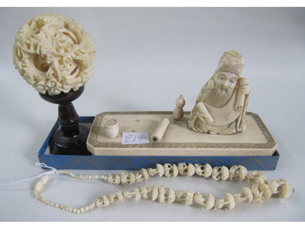 Appraisal: Lot comprising ivory puzzle ball on stand a figure on