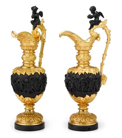 Appraisal: Pair of Continental gilt patinated metal ewers Each with a