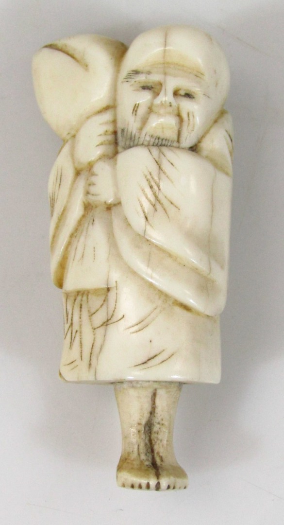 Appraisal: A Japanese Meiji period ivory netsuke formed as a standing