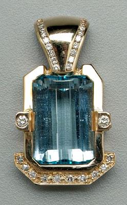 Appraisal: Blue topaz and diamond pendant one faceted emerald-cut blue topaz