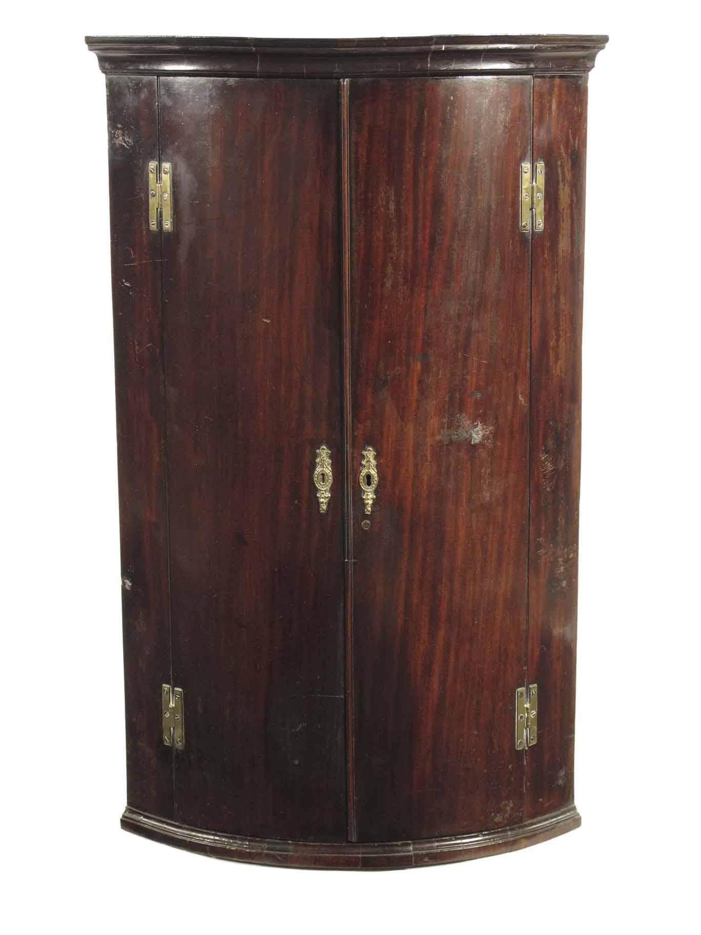 Appraisal: An early George III mahogany bowfront hanging corner cupboard