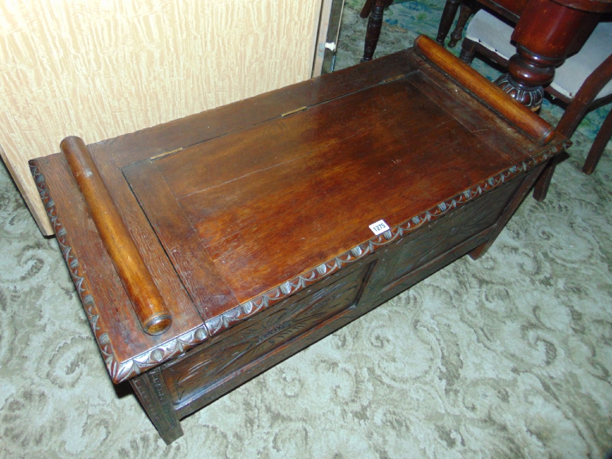 Appraisal: A carved oak hall bench seat with box seat and