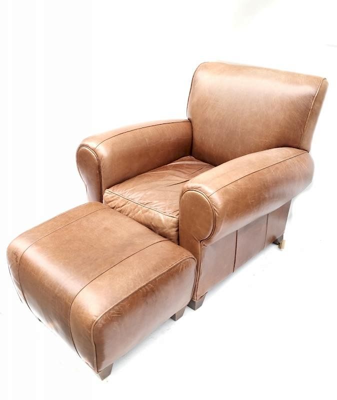 Appraisal: Leather Club chair and Ottoman Leather upholstered club chair with