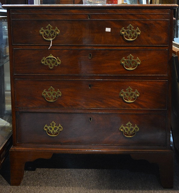 Appraisal: A George III mahogany secretaire chestthe upper drawer fitted with