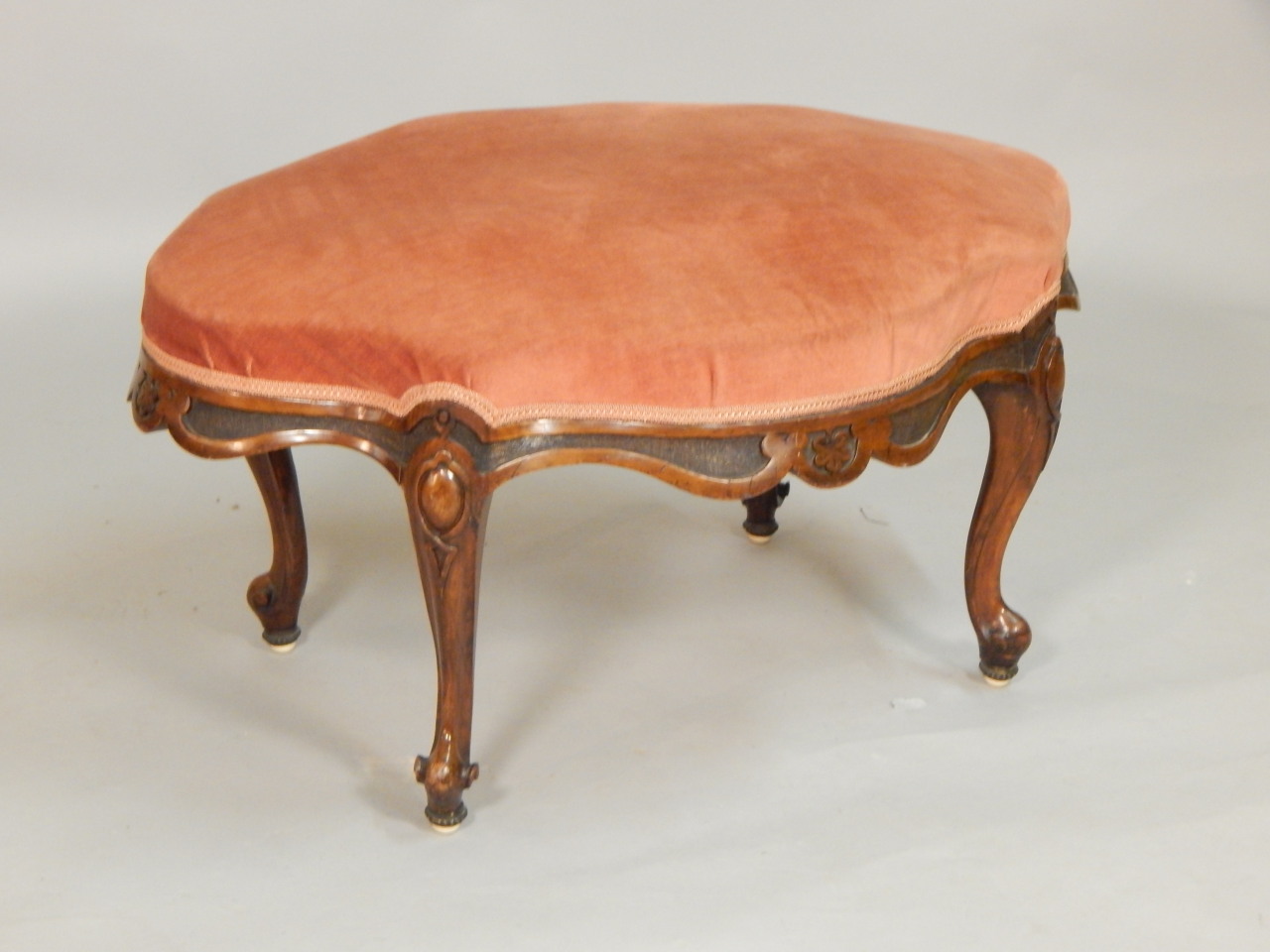 Appraisal: A Victorian walnut stool with a padded seat on a