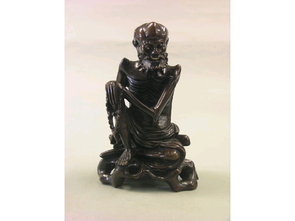 Appraisal: A Chinese carved hardwood figure of an elder bearded character