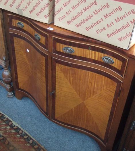 Appraisal: A rosewood and satinwood serpentine side cabinet of George III