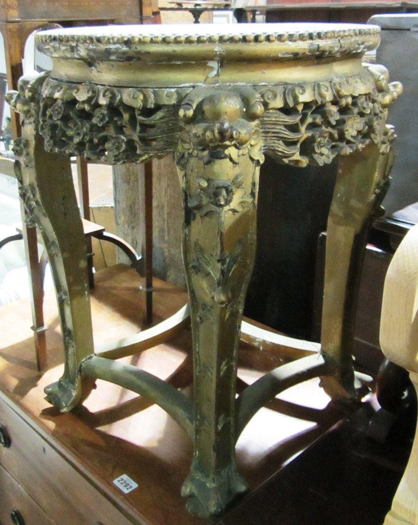 Appraisal: A gilt painted Oriental occasional table with prunis carved frieze