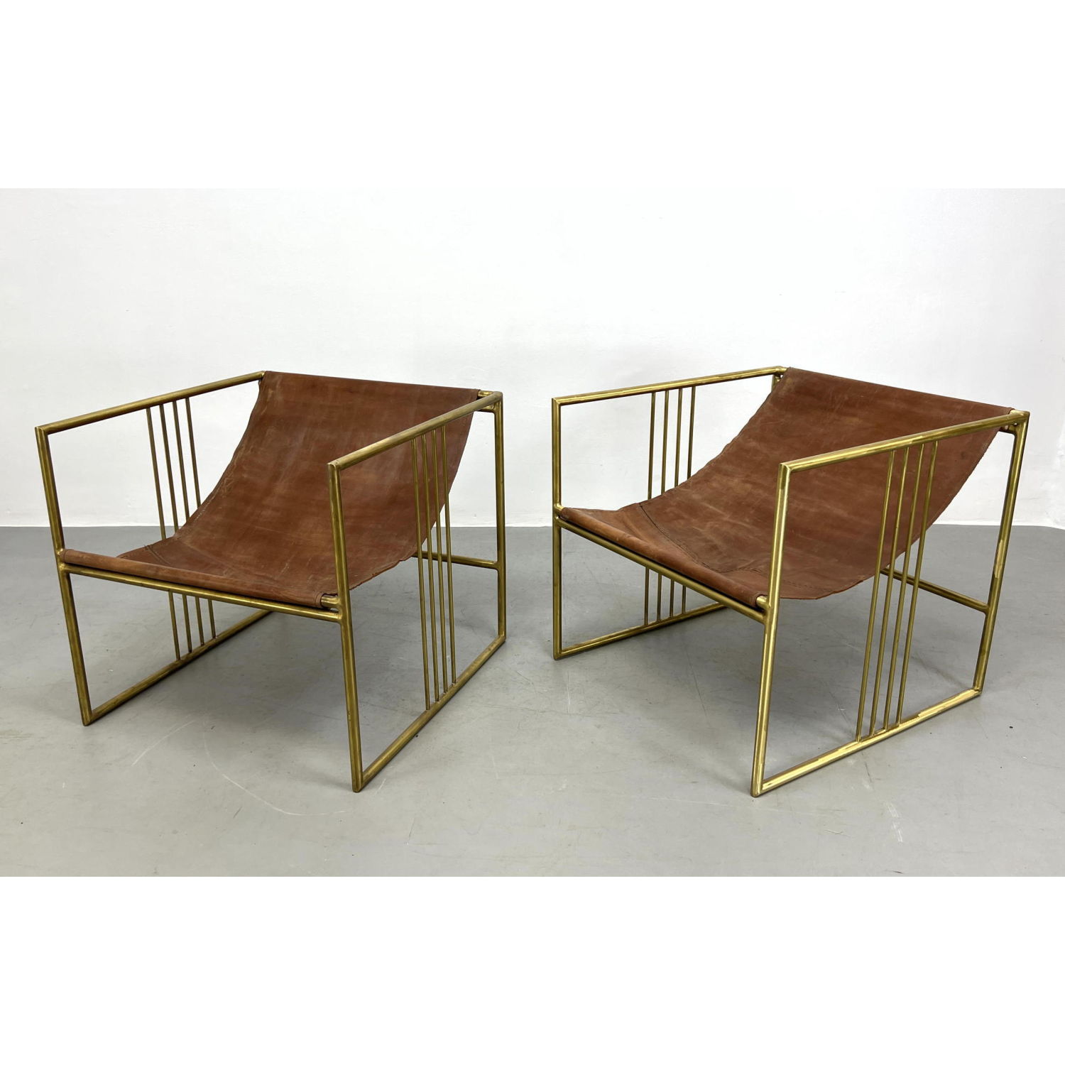 Appraisal: Pair Decorator Upon Brass Framed Lounge Chairs with Leather Sling