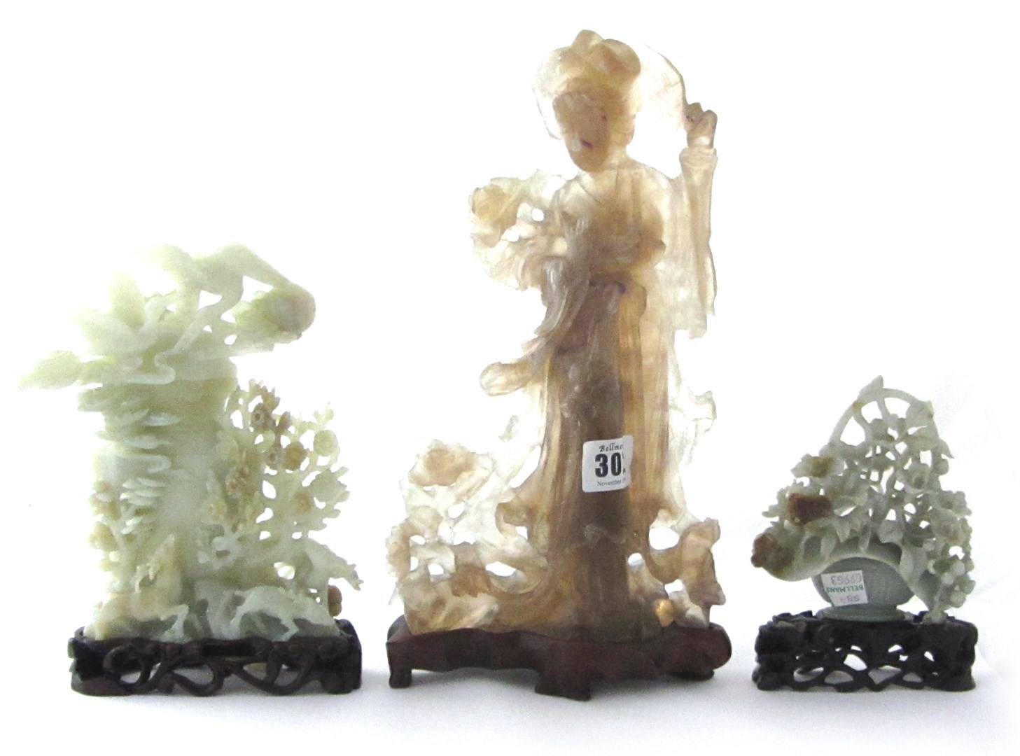 Appraisal: A smokey crystal carving of a lady th century holding