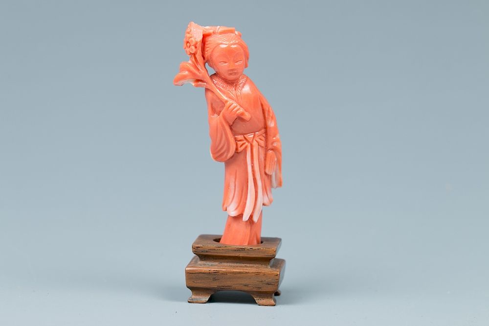 Appraisal: CORAL FIGURE CARVING Depicting a standing figure holding a flower