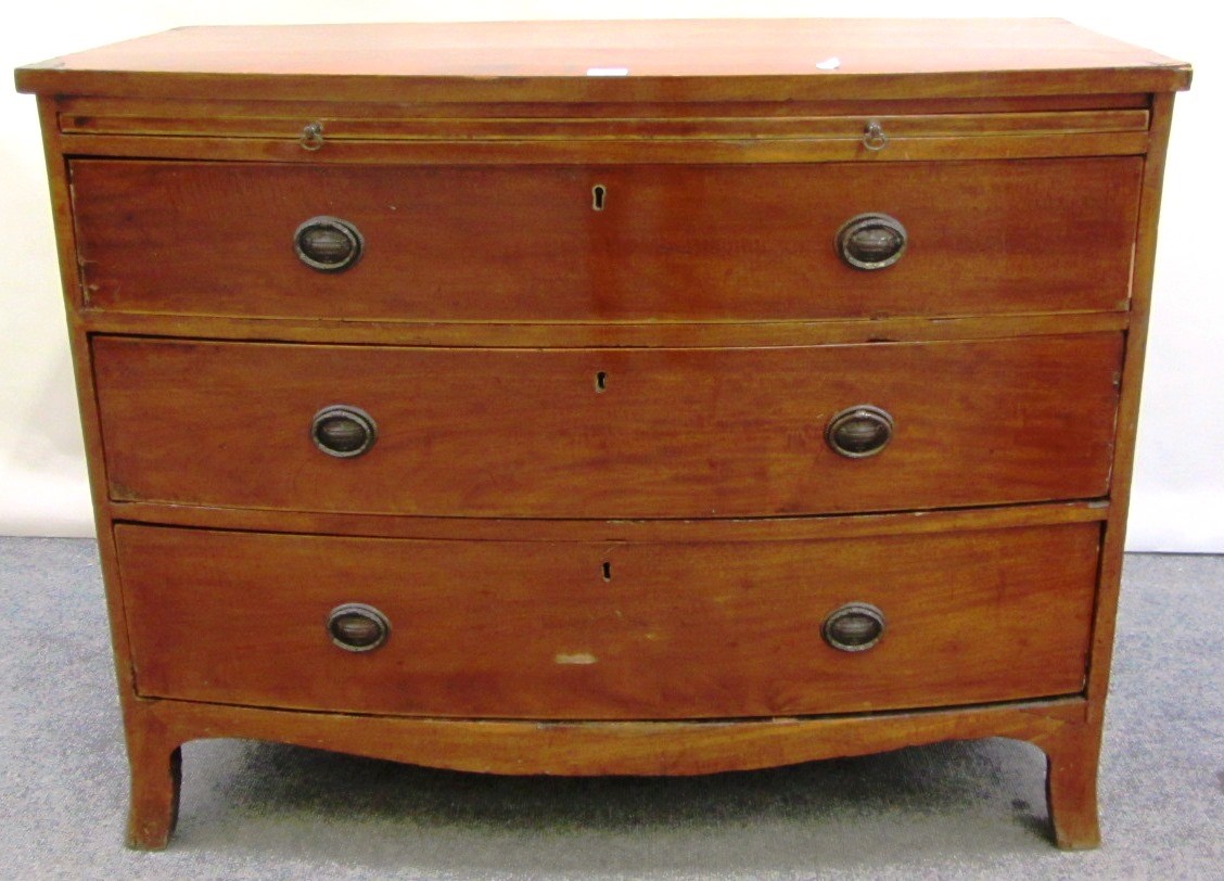 Appraisal: A Regency mahogany bow front chest with brushing slide over