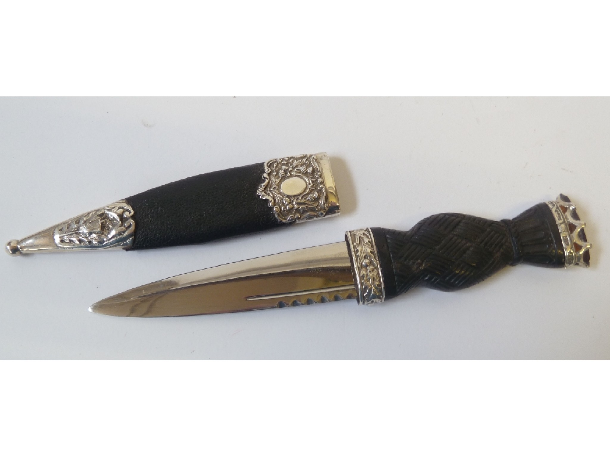 Appraisal: A MODERN SCOTTISH SILVER MOUNTED DIRK with shaped and carved