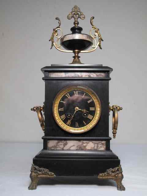 Appraisal: Black granite variegated marble and gilt bronze mantle clock Glass