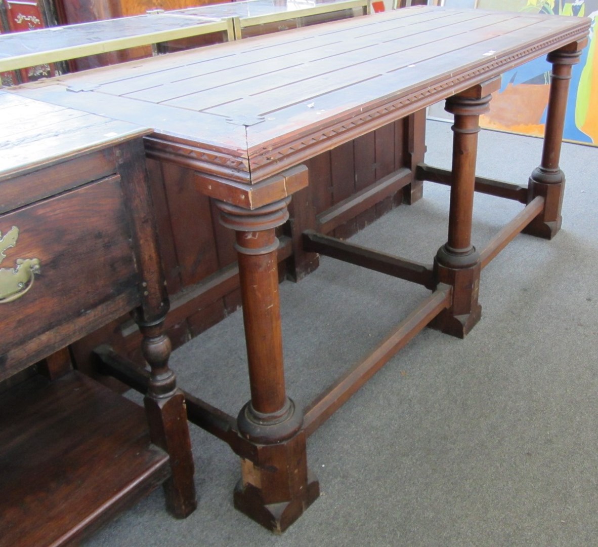 Appraisal: A stained pine Gothic Revival altar table on three turned