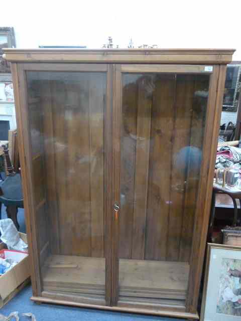 Appraisal: A PINE TWO DOOR GLAZED FLOOR STANDING CABINET with adjustable