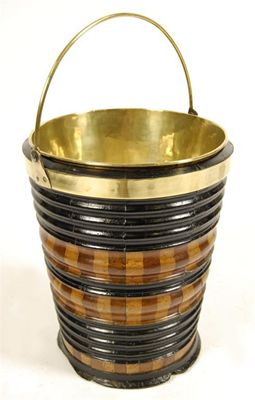 Appraisal: A Dutch ebonised mahogany and fruitwood bucket with a brass