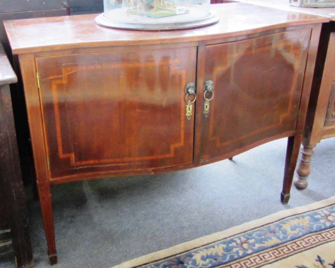 Appraisal: A th century inlaid mahogany serpentine two door side cabinet