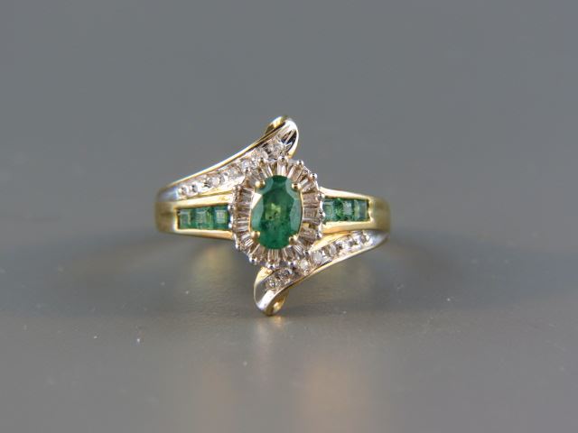 Appraisal: Emerald Diamond Ring oval emerald with square cut emeralds on