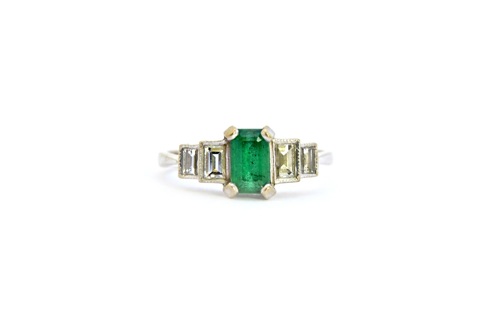 Appraisal: A white gold emerald and diamond ring claw set with