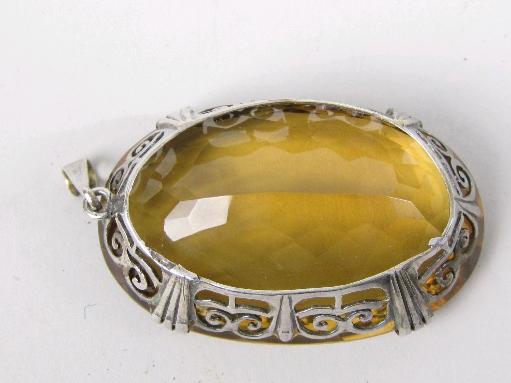 Appraisal: A large Citrine Pendant the oval-cut stone claw-set in pierced