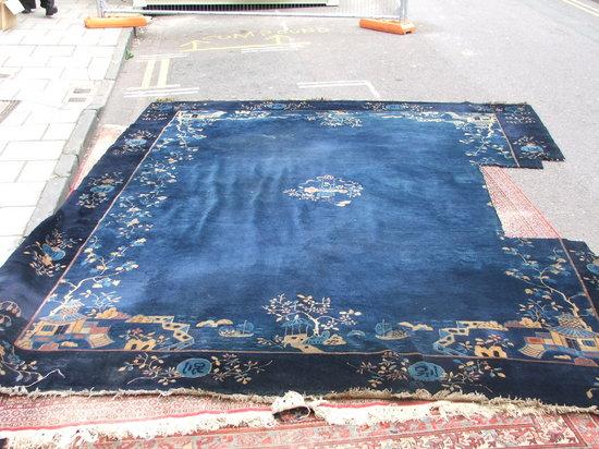 Appraisal: AN OLD CHINESE BLUE GROUND CARPET with simple landscape decoration