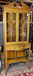 Appraisal: Neoclassical style paint-decorated bookcase on stand having a broken arch