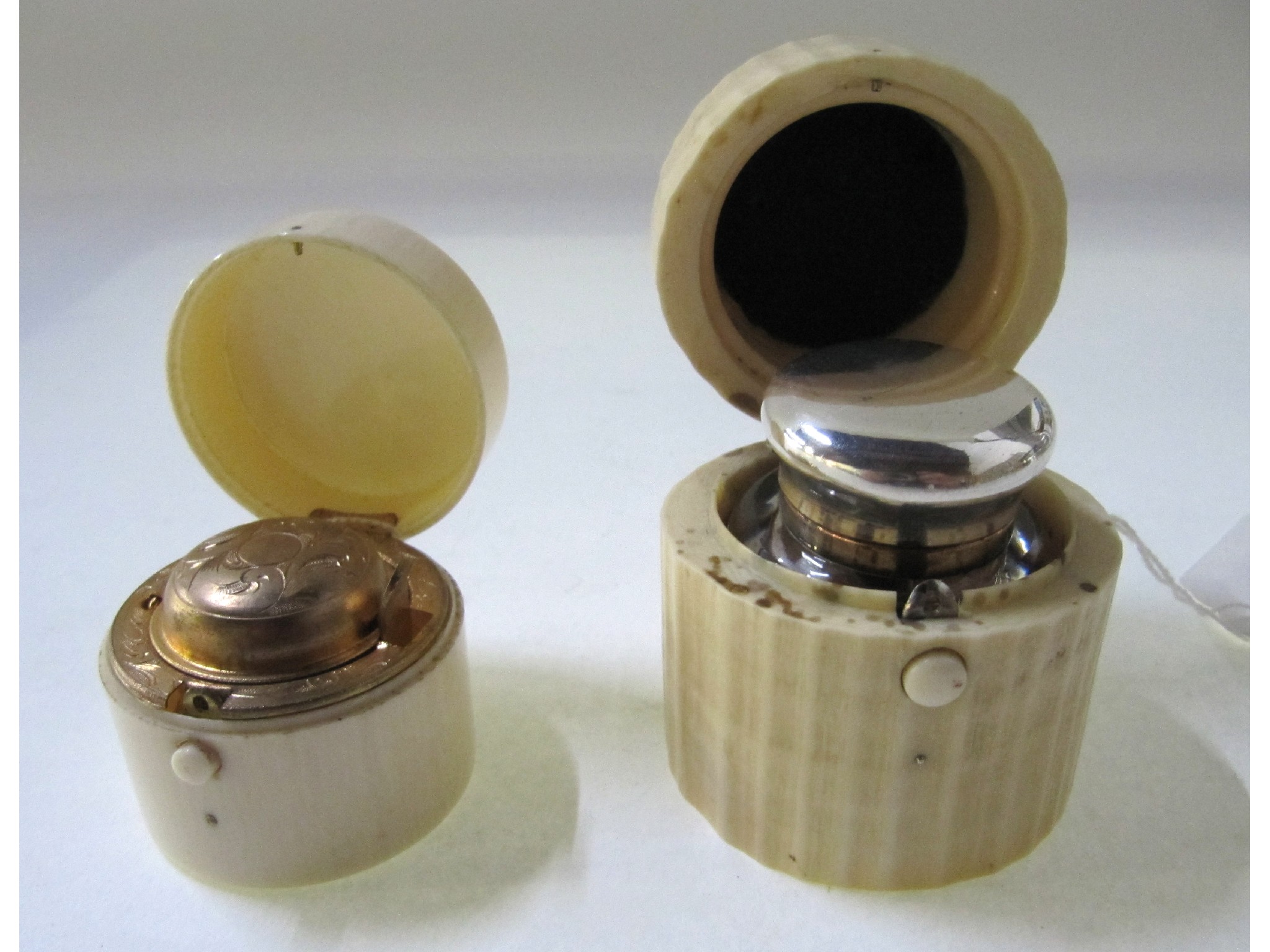 Appraisal: A lot comprising two ivory cased travel inkwells