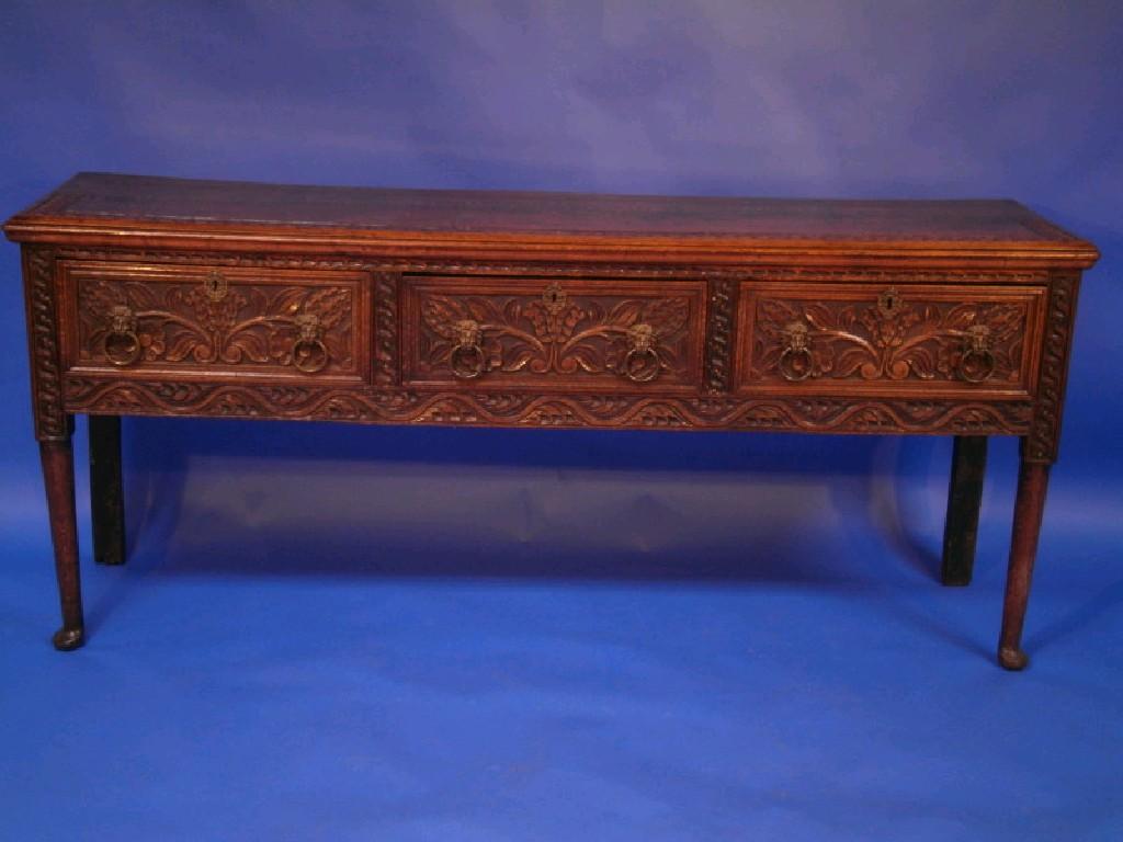 Appraisal: A Victorian carved oak dresser base with three frieze drawers