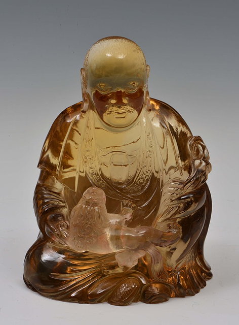 Appraisal: A CHINESE SMOKY QUARTZ MODEL of a seated buddha holding