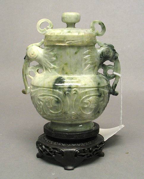 Appraisal: A mottled green and white jadeite oval-sectioned vase and cover