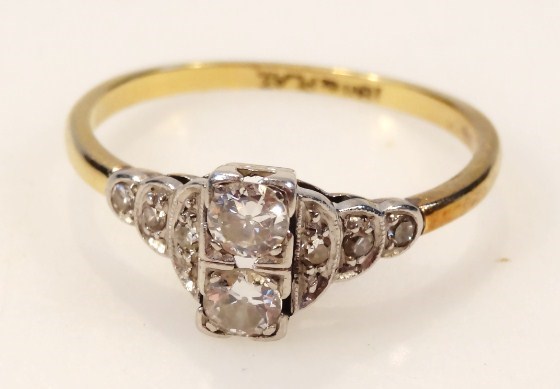 Appraisal: An Art Deco design dress ring centred by two diamonds