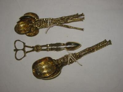 Appraisal: A PAIR OF SILVER GILT SUGAR NIPS the bowls chased