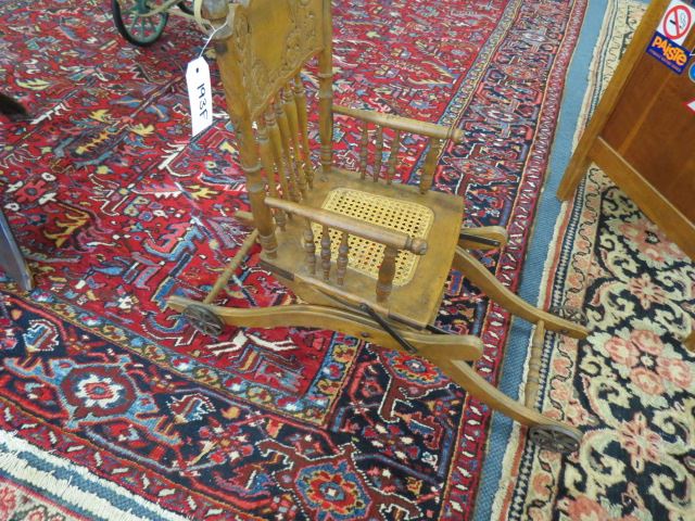 Appraisal: Antique Highchair Stroller Combination pressed back spindle decor cane seat