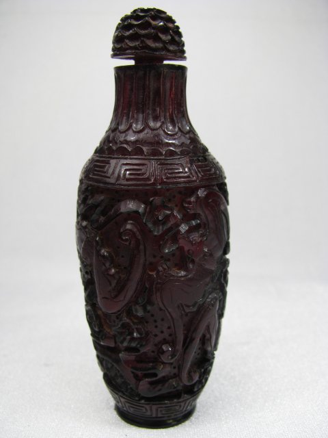 Appraisal: Tall slender cylinder shape Chinese amber carved snuff bottle with