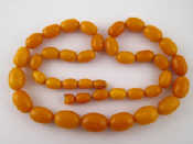 Appraisal: An amber necklace approx cm long largest bead approx cm