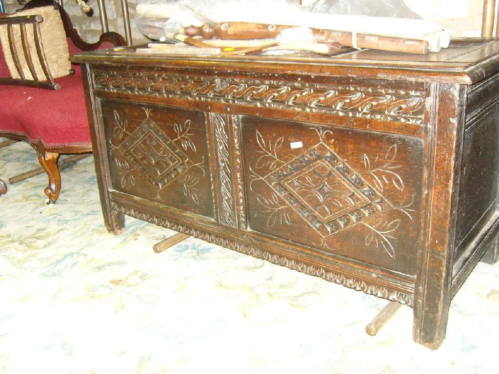 Appraisal: An early th century panelled oak coffer with carved detail