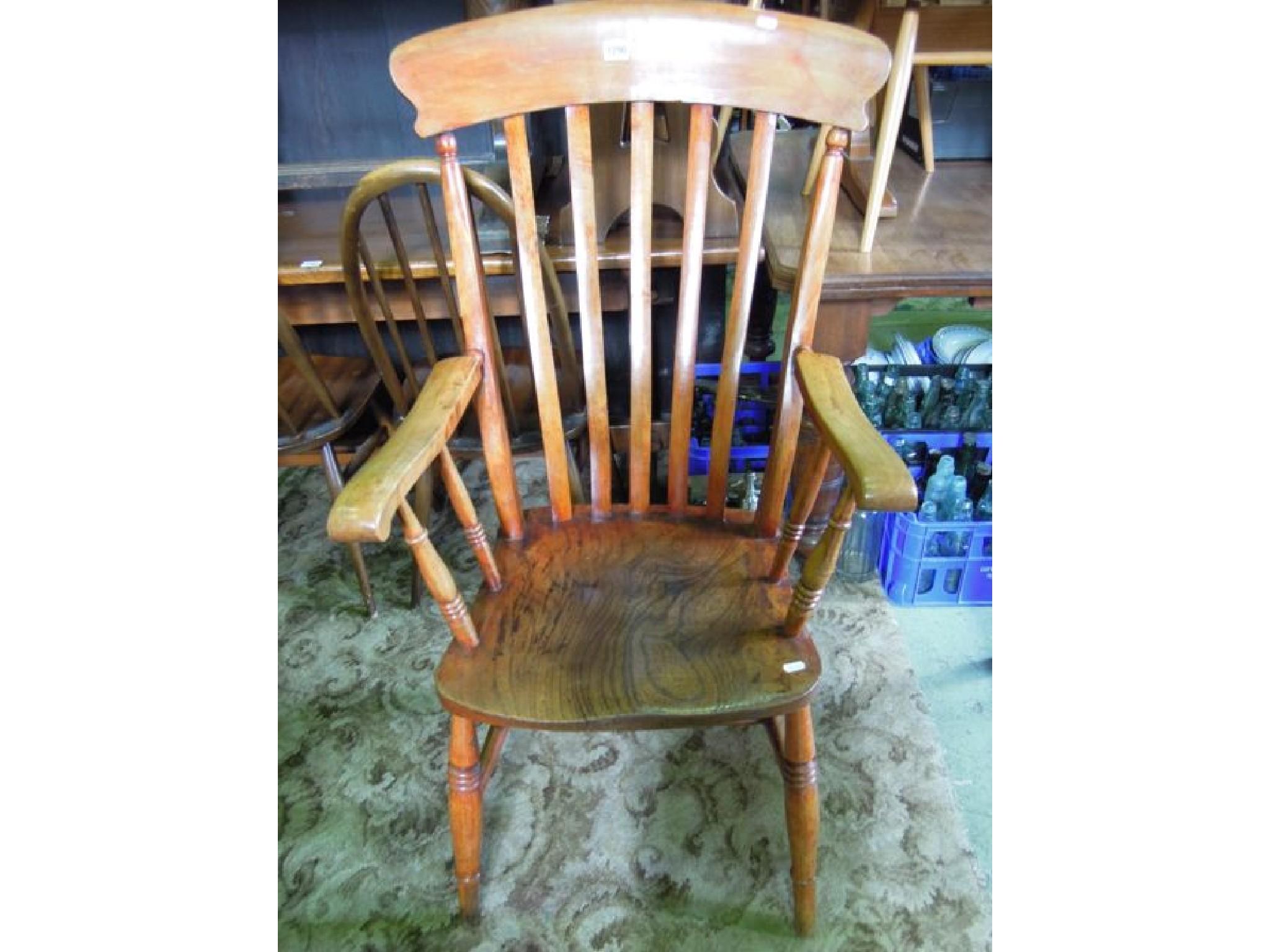 Appraisal: A stained elm and beechwood lathe back kitchen elbow chair