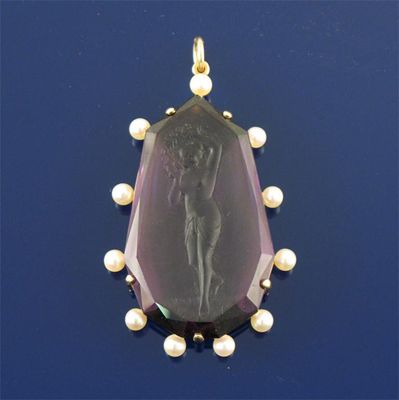 Appraisal: An amethyst cameo pendant depicting a scantily clad woman within