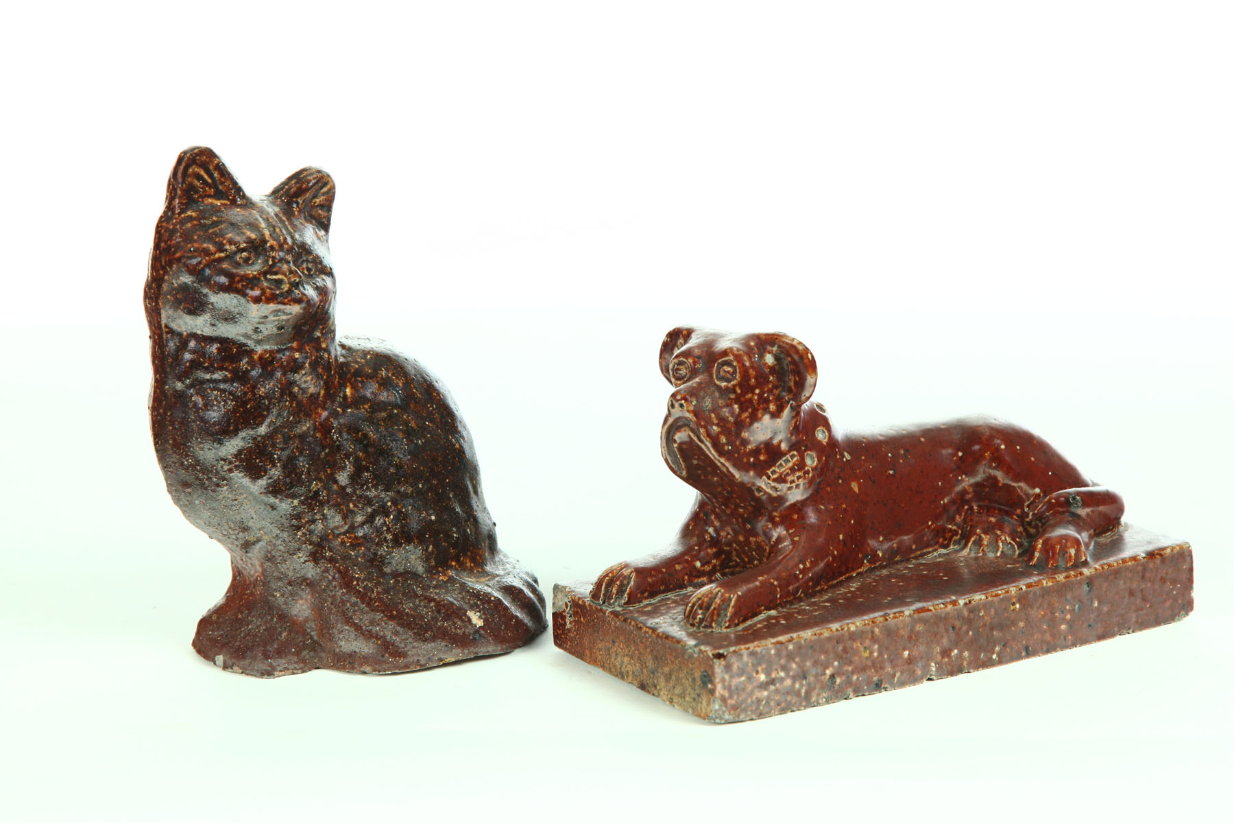 Appraisal: SEWERTILE DOG AND CAT Ohio early th century Reclining mastiff