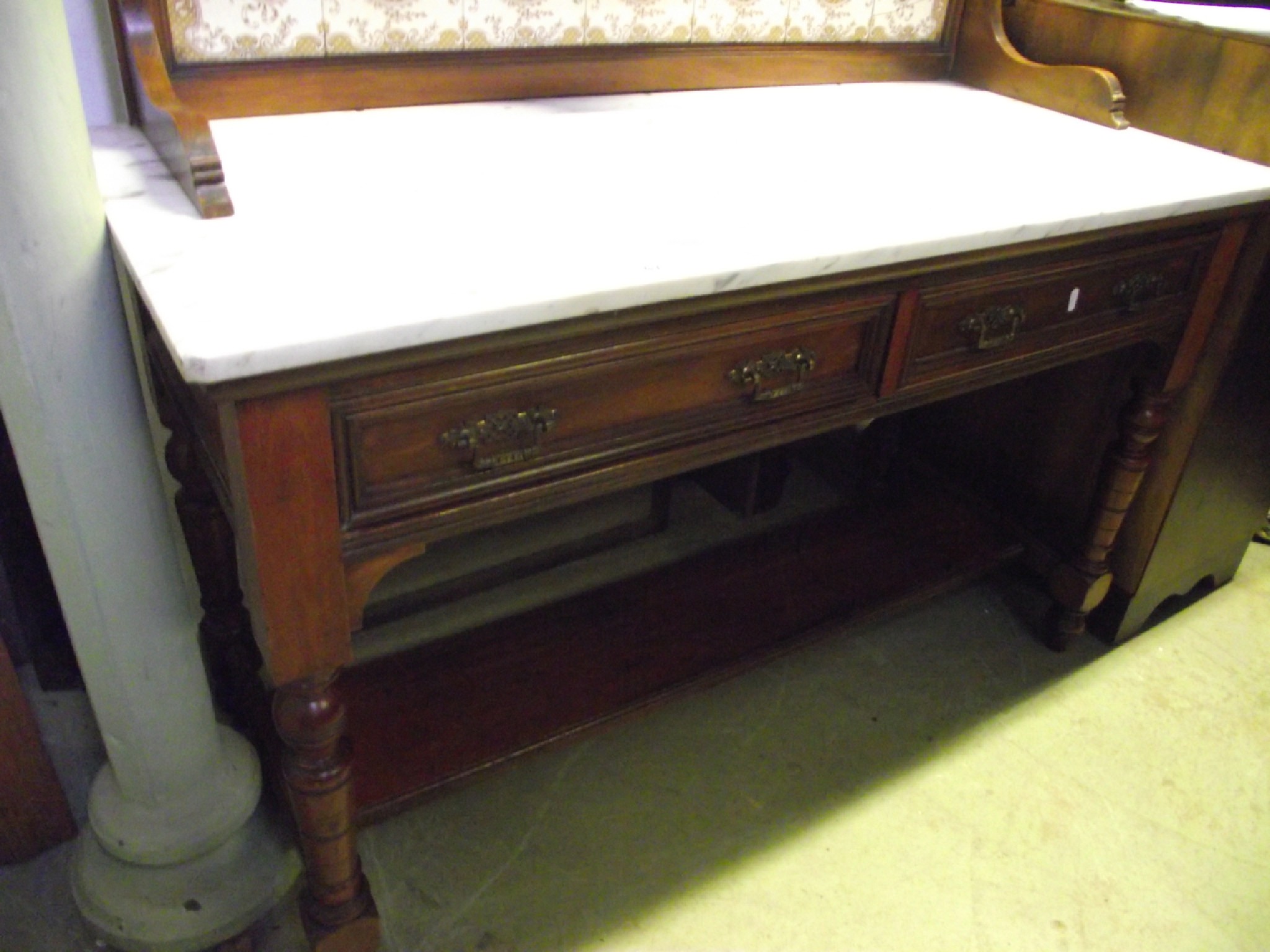 Appraisal: A late Victorian walnut washstand with white and grey flecked