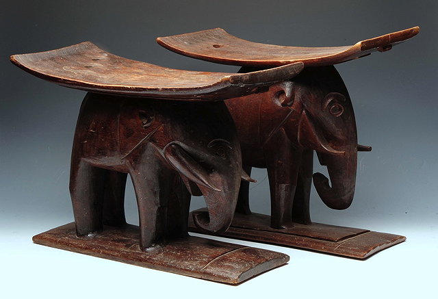 Appraisal: A PAIR OF AFRICAN TRIBAL CARVED WOODEN STOOLS of shaped