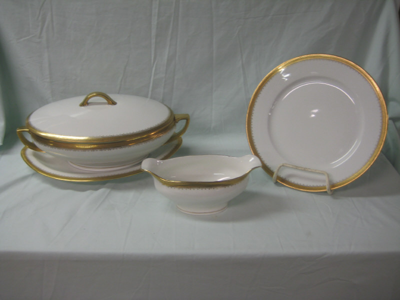 Appraisal: OSCAR EDGAR GUETHERZ ALTROHLAU AUSTRIA Gold rimmed porcelain dinner service