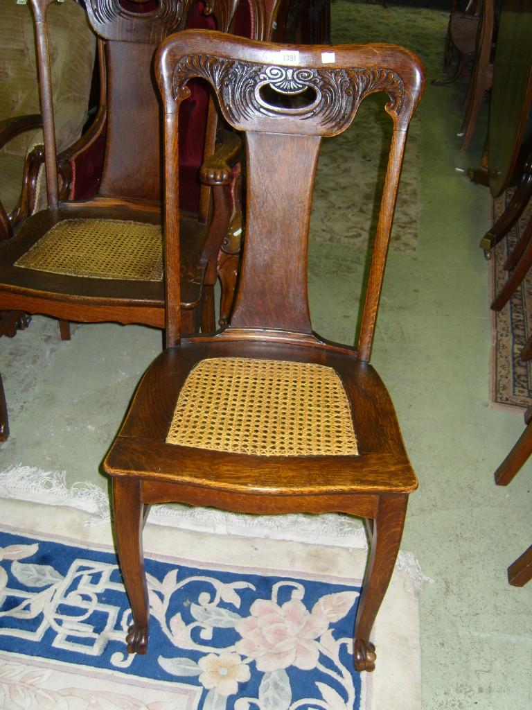 Appraisal: A set of six oak dining chairs the shaped backs