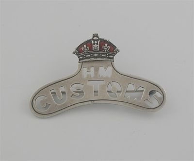 Appraisal: An Edwardian 'customs' badge curved and pierced 'HM CUSTOMS' below