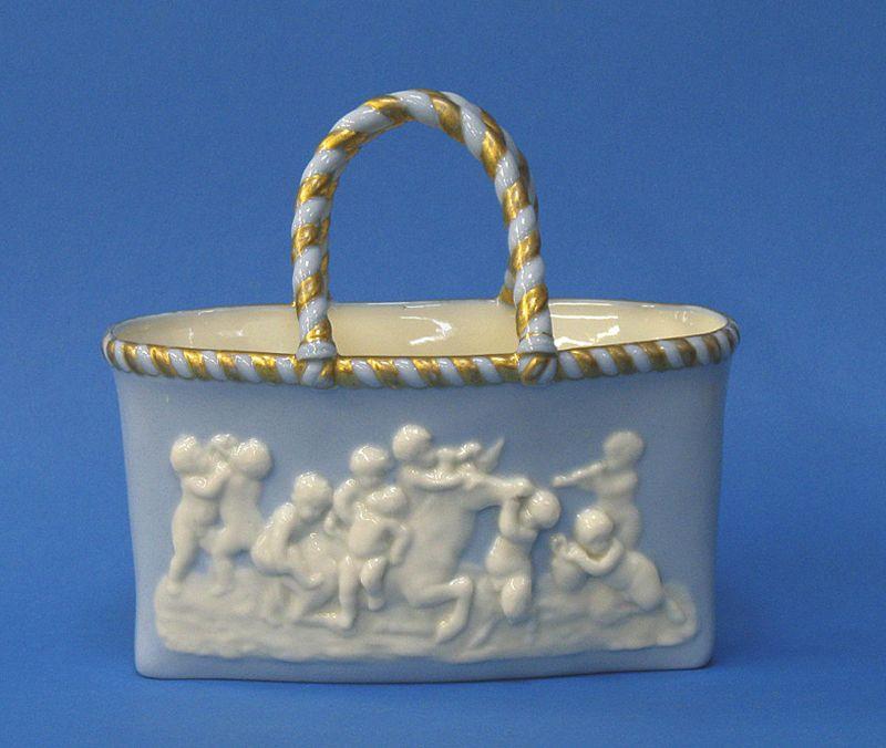 Appraisal: A ROYAL WORCESTER BASKET of oval form the pale blue