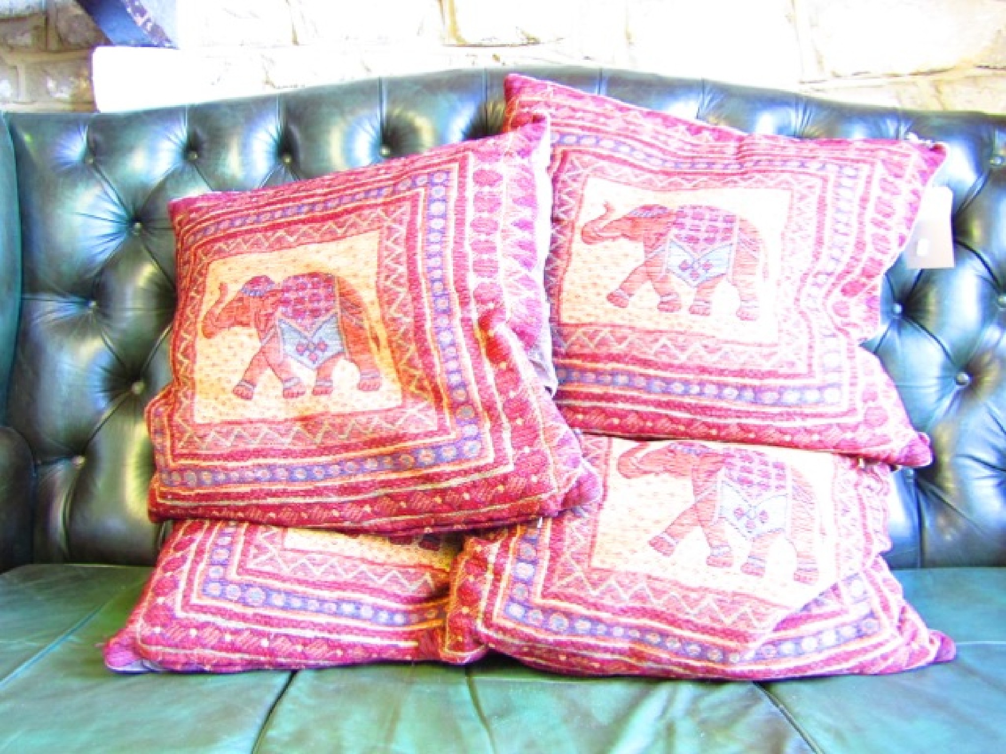 Appraisal: Four square Indian style feather filled loose cushions velvet backed